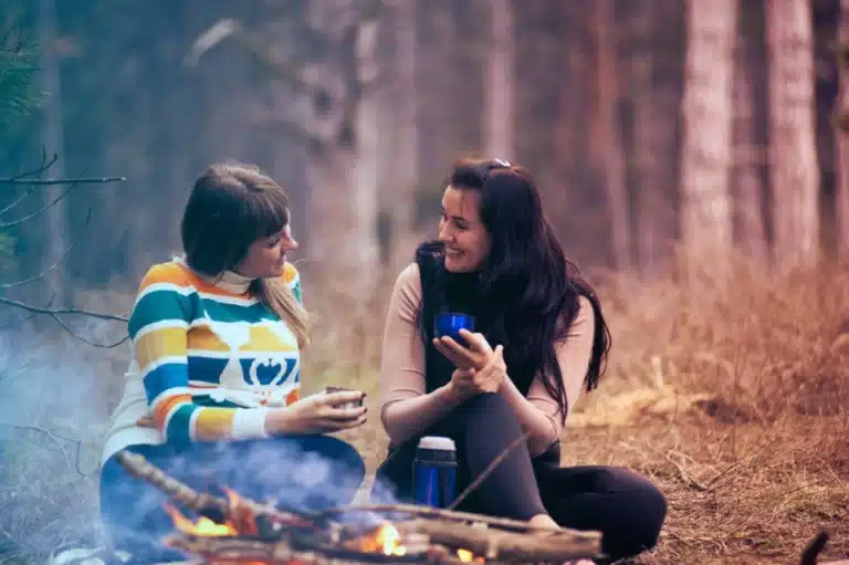 Canva-Two-Women-Sitting-on-Ground-Near-Bonfire